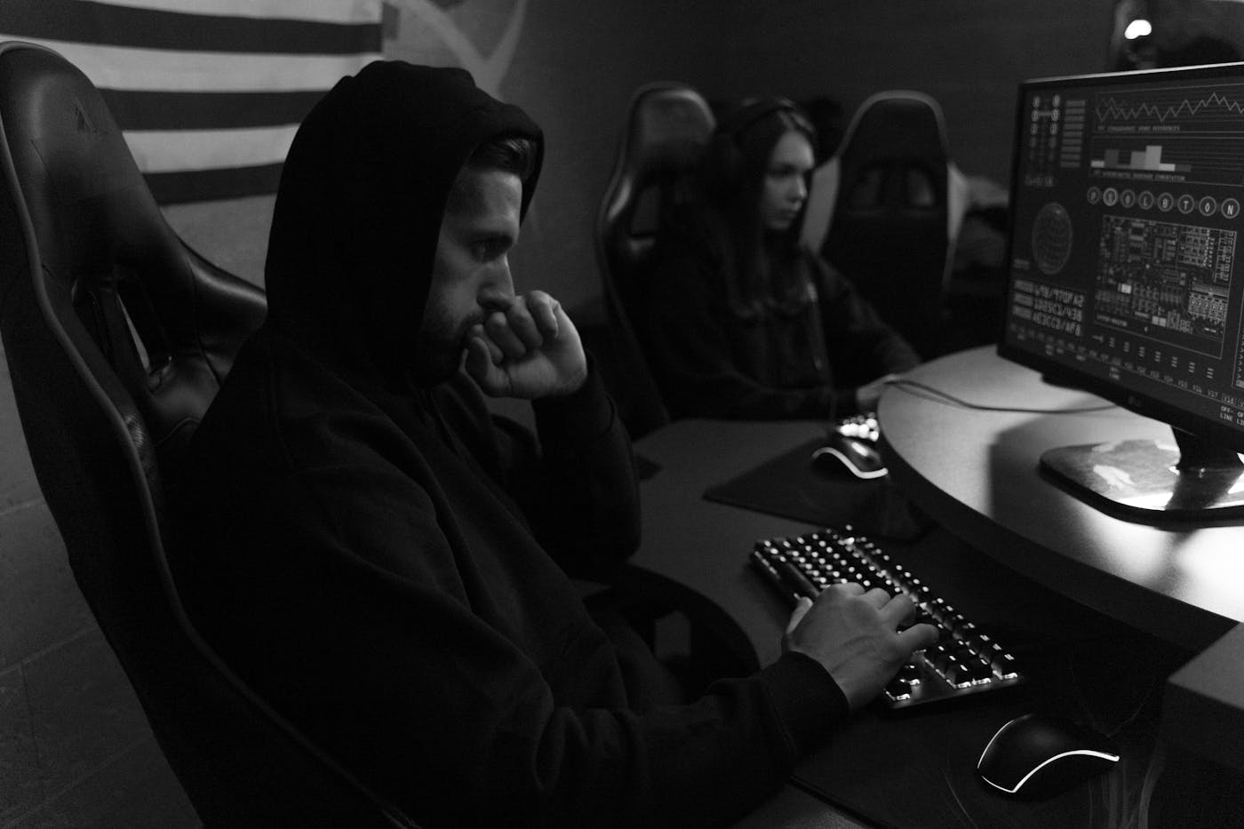 Black and white technology team working at computer monitors